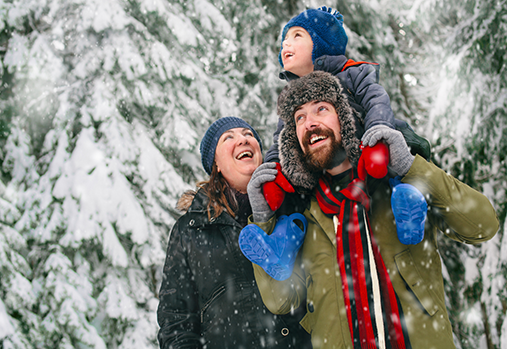 Man, woman and child outside in the snow