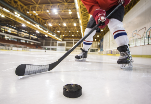 Hockey player facing off with puck