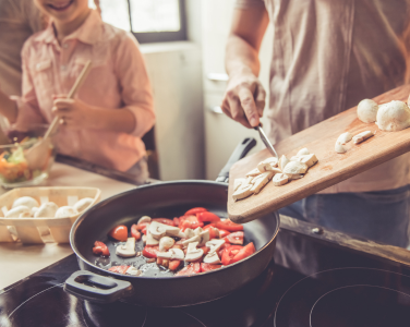 A family cooking and preparing food together.