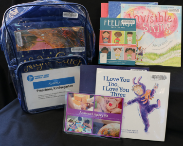 A display of children's books and an educational backpack kit.