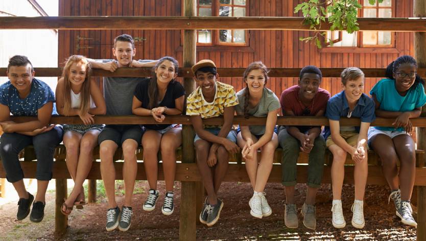 teens sitting outside on a dock