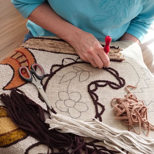 people rug hooking together