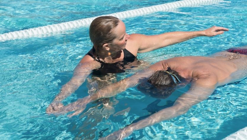 Adult swimming class in outdoor pool