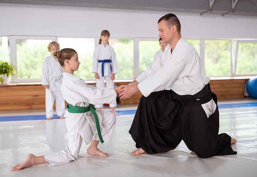 children and instructor practicing Aikido