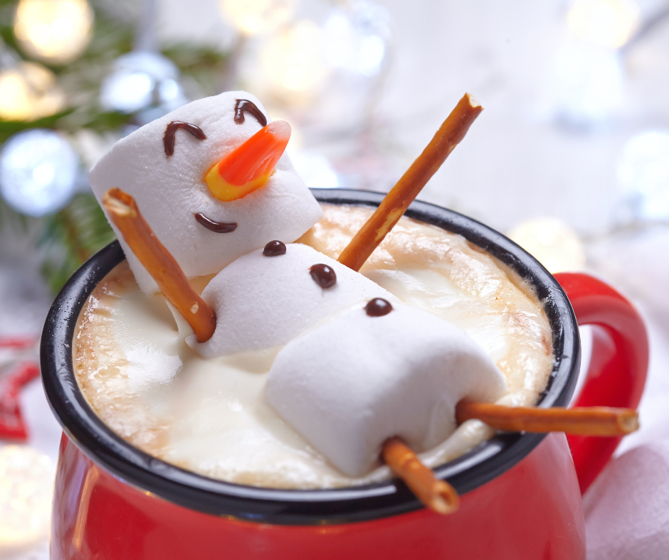 Family of four enjoying the snow falling outdoors