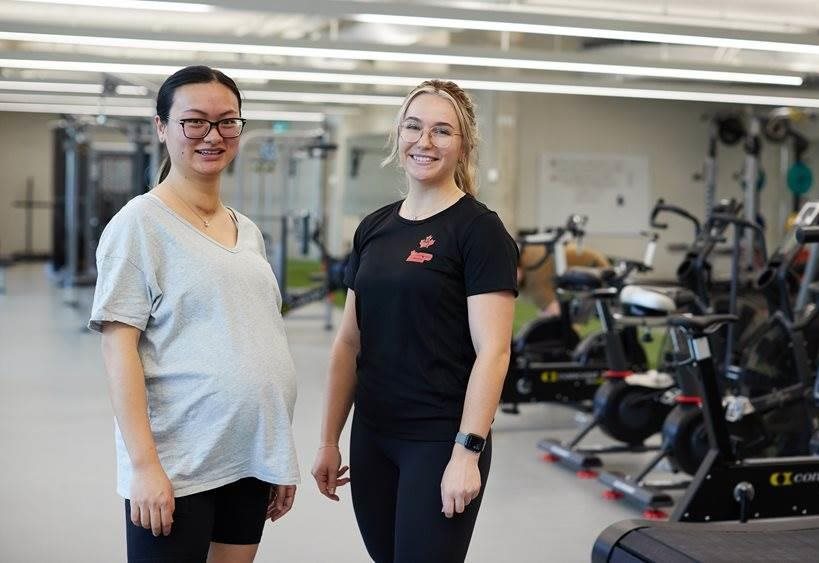 CAF member and PSP staff standing side by side smiling