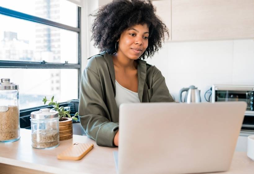 woman filling out an online registration form at home