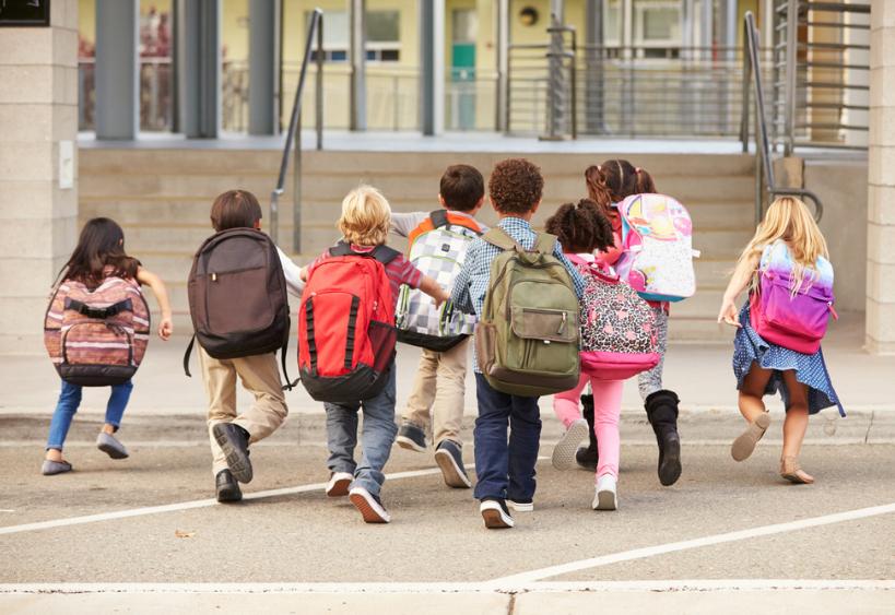 Kids running towards school