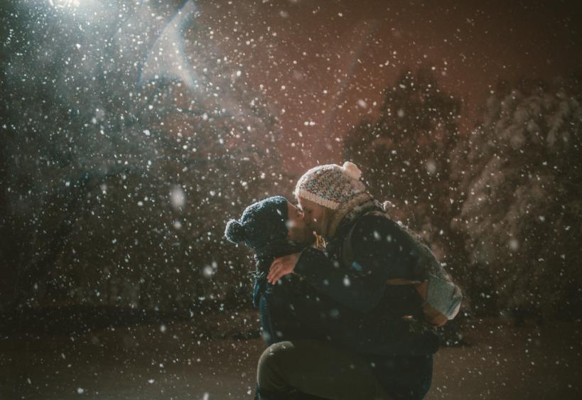 A couple kissing in the snow