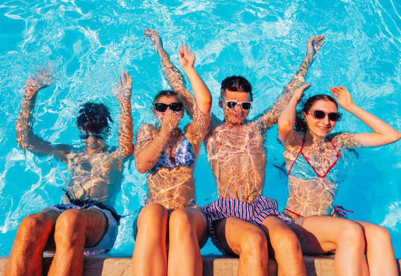 Teens in swimsuits and sunglasses in the pool