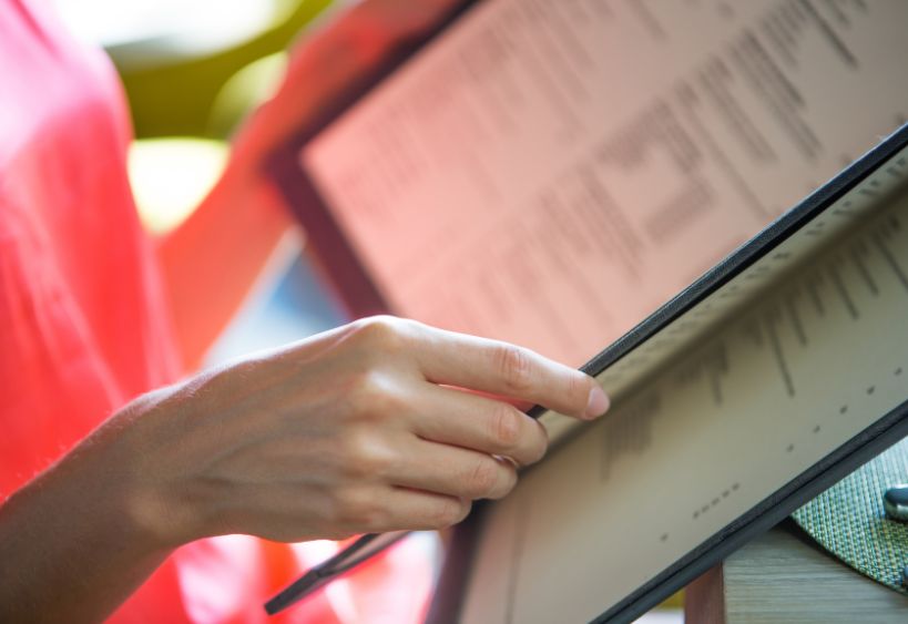 Woman looking at a cafeteria menu