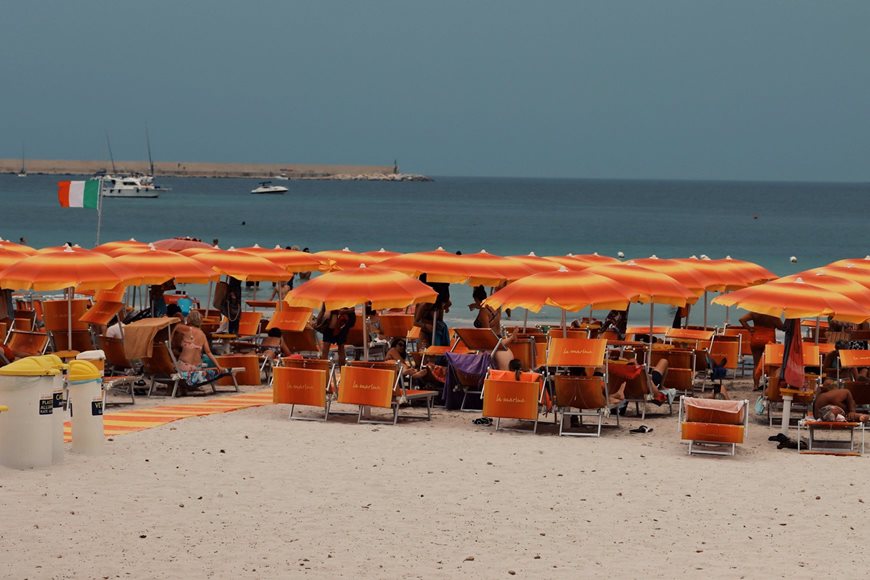 Rows of brightly coloured beach chairs and umbrellas