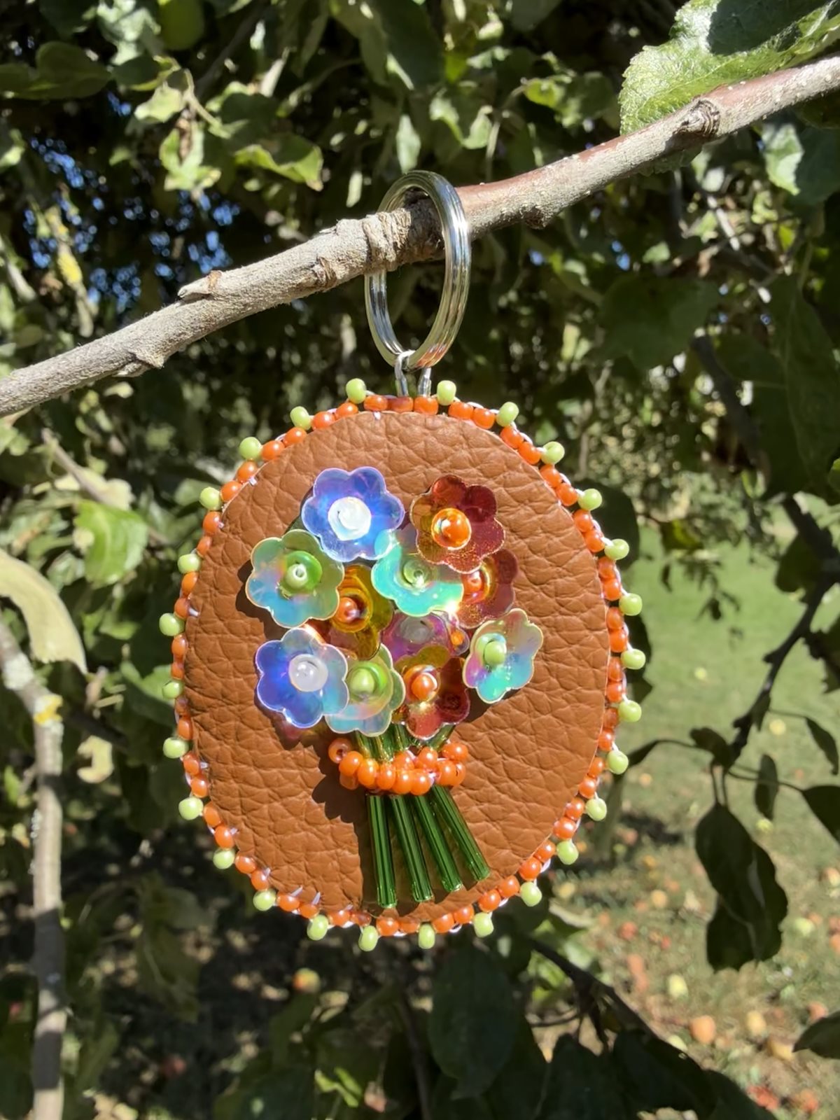 Beaded leather keychain on branch