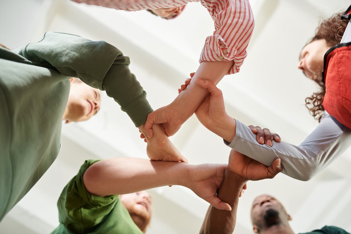 Group of people linking arms