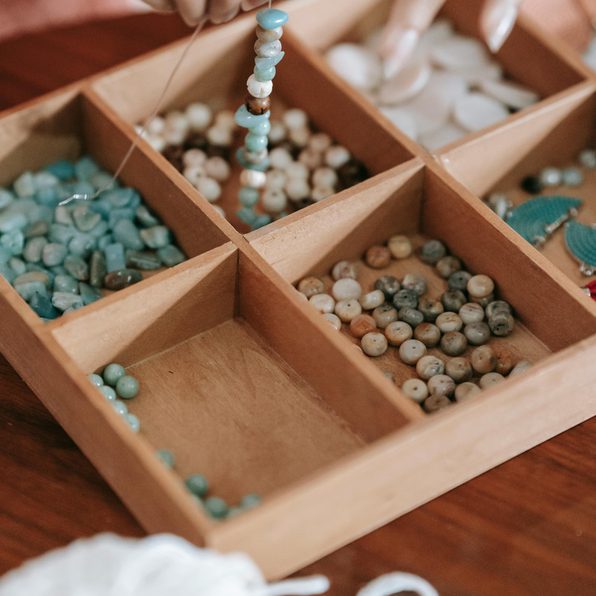 wooden tray with an assortment of beads for jewellery making