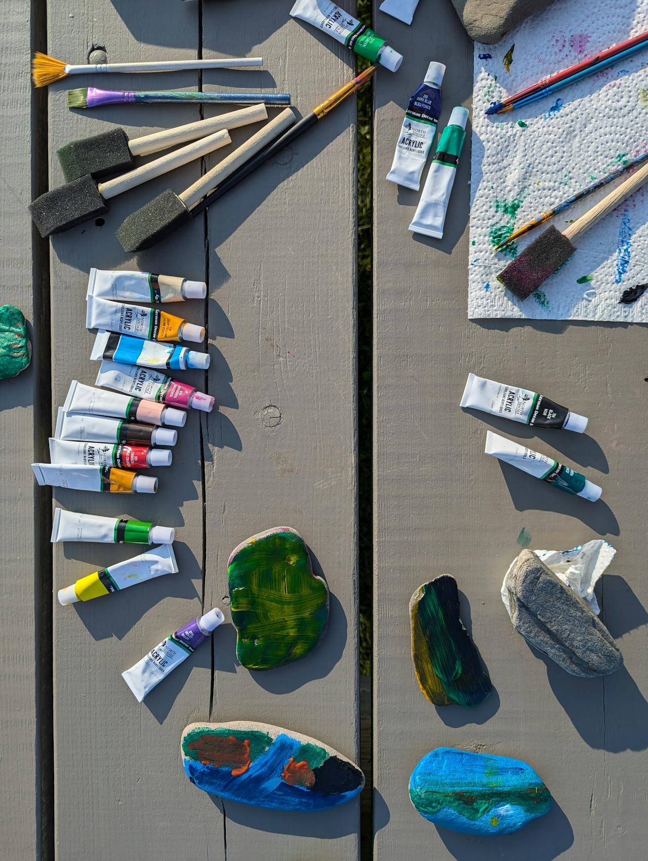 Acrylic Paints and Brushes on Outdoor Wooden Table