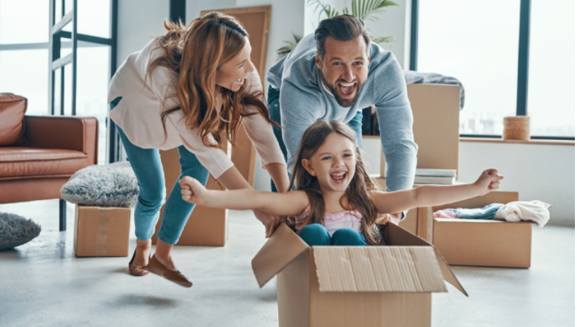 parents pushing daughter in a box