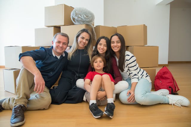 Family sitting on floor in front of boxes