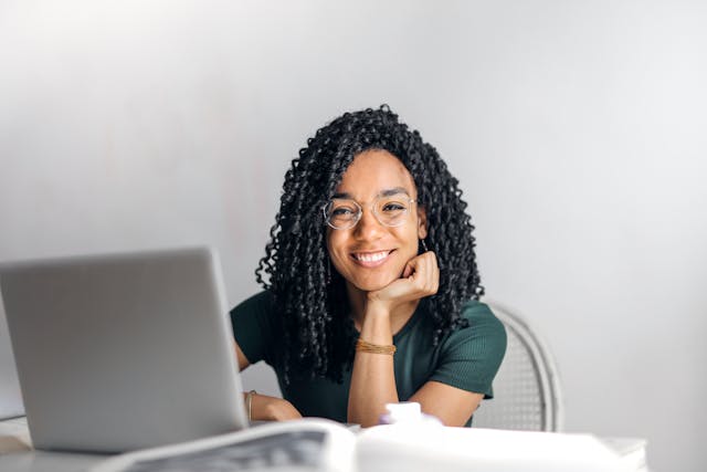 woman sitting at desk and smiling