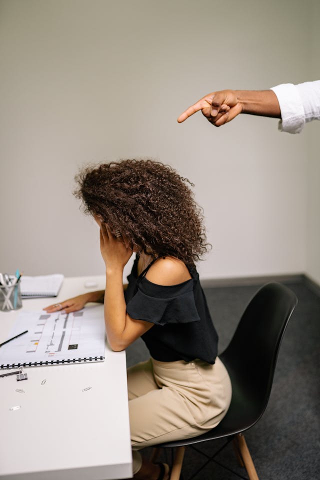 Pointing finger at woman sitting on chair while reviewing chart