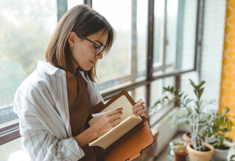 woman writing in notebook