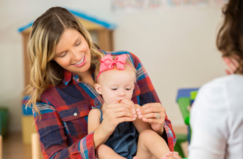 Mother teaching child hand sign