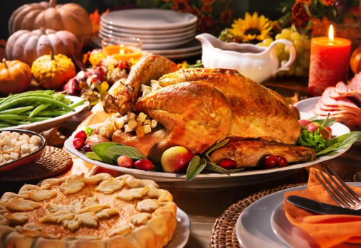 a table filled with a traditional Thanksgiving dinner & decorations