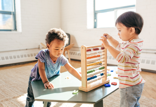 toddlers playing with toys on a table