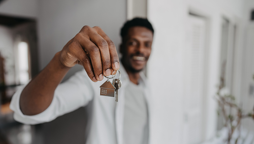 Man holding house keys out 
