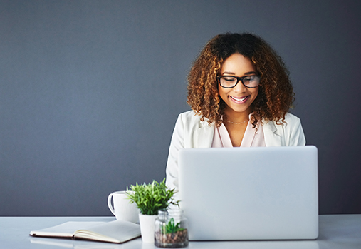 happy woman working on laptop