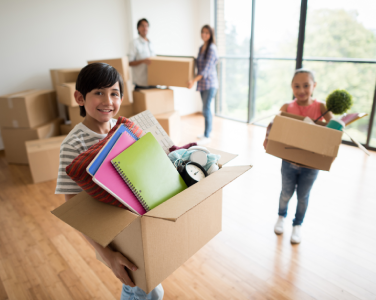 Kids holding moving boxes
