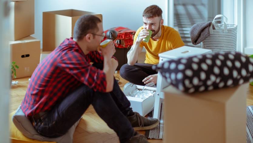 Men sitting on the ground drinking coffee