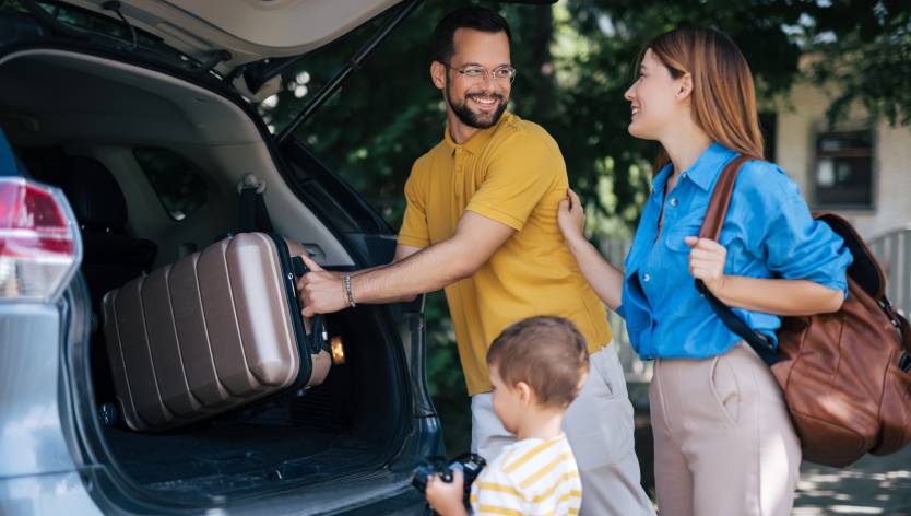 Family packing a bag in the car