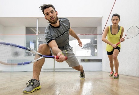 Woman coaches man in squash