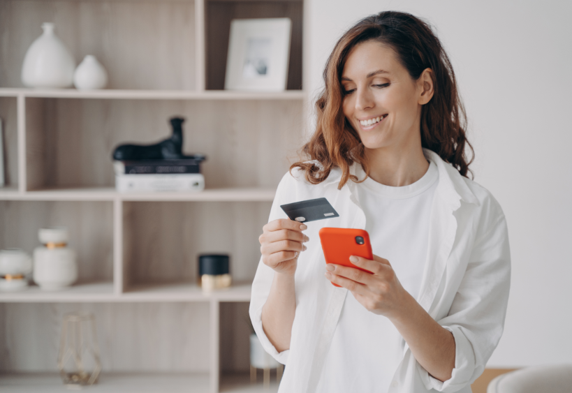 Woman holding phone and credit card