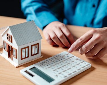House model next to a calculator