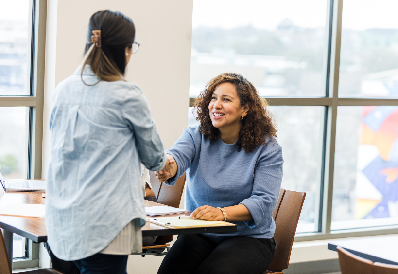 Two women shaking hands