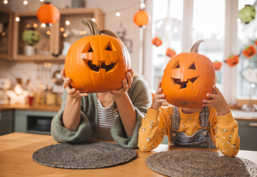 Family holding carved pumkins
