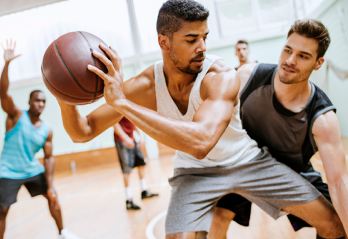Adults playing basketball