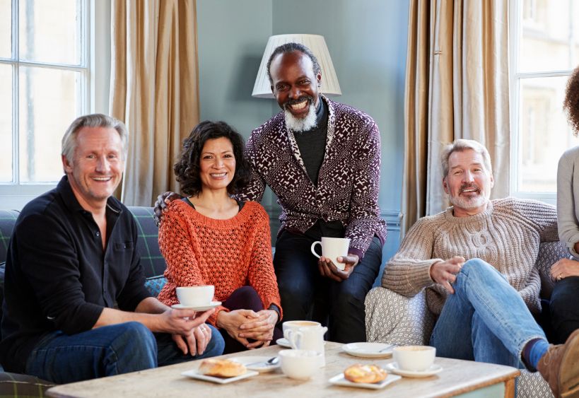 group of man and women sitting together over coffee