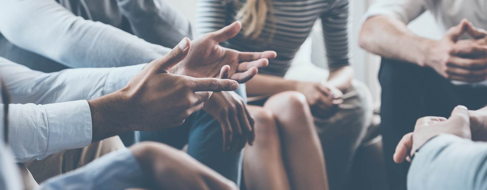 the hands of a group of people in conversation