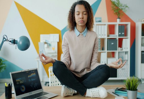 Person meditating on a desk