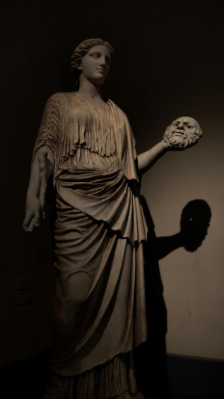 A marble statue on display at a museum