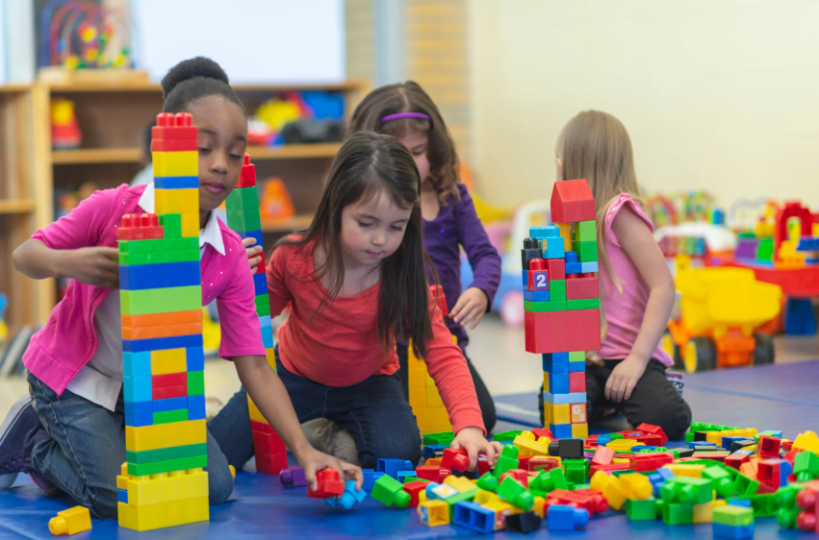 A group of children playing with building blocks